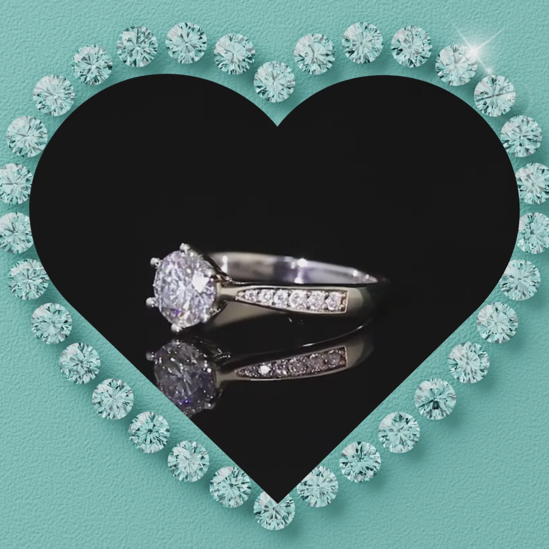 Round moissanite ring with polished band and delicate side stone detailing