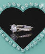 Round moissanite ring with polished band and delicate side stone detailing