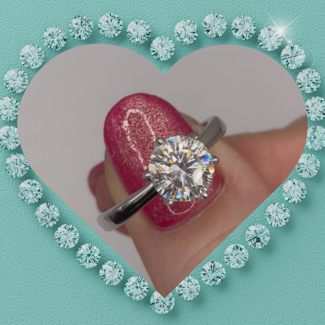 Timeless round moissanite solitaire ring with polished silver tone band