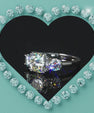 Cushion cut solitaire ring with side stone accents and polished band